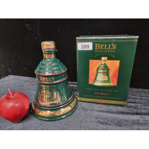 209 - A sealed Bell's Extra Special Old Scotch Whisky Christmas Decanter 1995. In original box with seal.