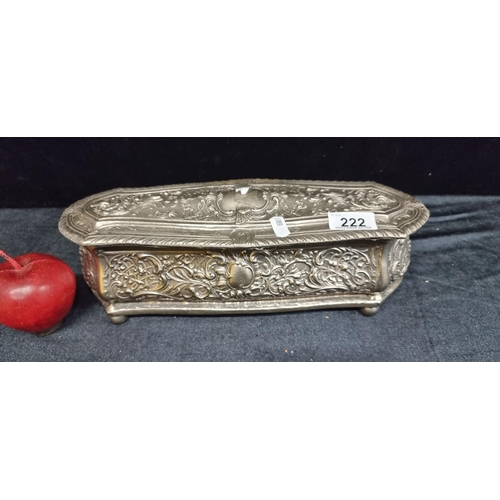 222 - A long, heavy, cast metal embossed jewellery box with hinged lid to top, velvet-lined interior and h... 