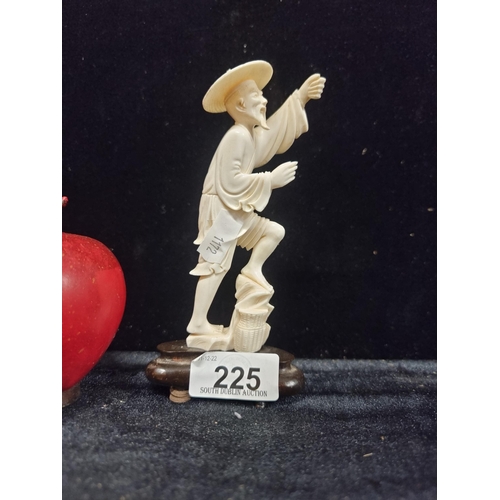 225 - An antique 19th century delightful bone carved figurine of a worker in traditional eastern Asian dre... 