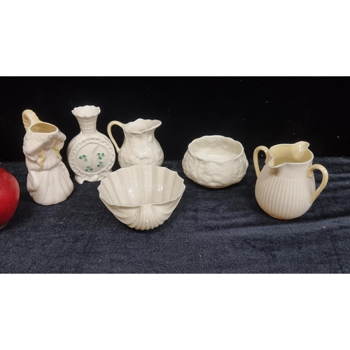 233 - A selection of six vintage Belleek items, including a shell pin dish, a two-spout cream jug and a ba... 