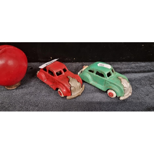 255 - Two cast metal items in the form of antique cars, one in green and another in red.