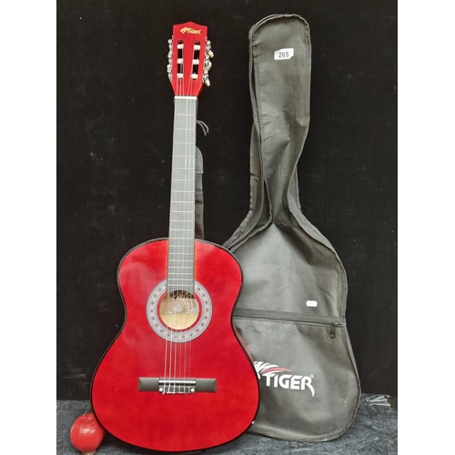 265 - A Tiger acoustic Spanish guitar model no. CLG4-RD with a striking red finish. Comes with original ca... 