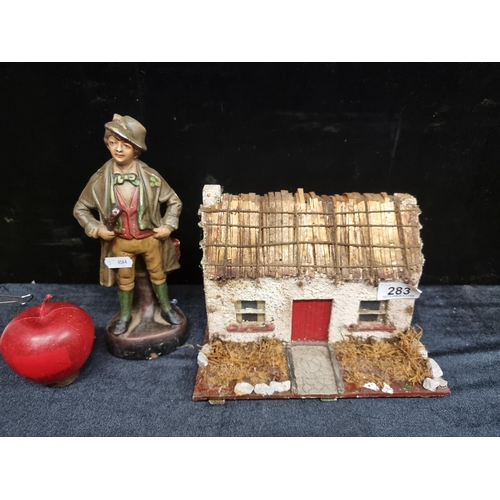 283 - Two charming items of historical Irish interest, including a model straw thatched cottage with white... 