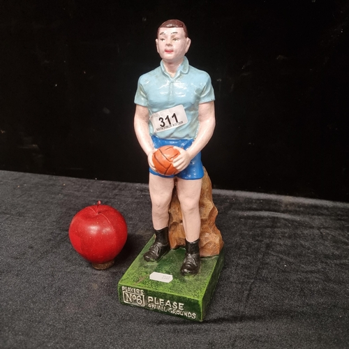 311 - A collectable figure of a GAA player reading 