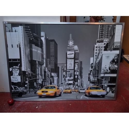 331 - A very large canvas print of a black and white New York Times Square with bright yellow taxi's.