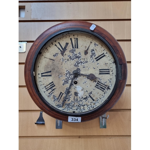 An antique John Carter, London 1 day wall clock with mahogany round frame and patina'd face with roman numerals.
