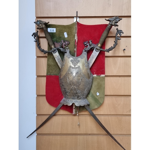 335 - A good sized wall heraldic wall piece with real swords with dragon Pommels and breastplate to centre... 