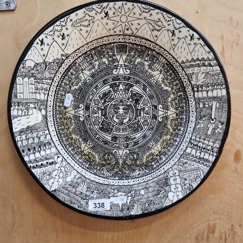 338 - A stunning large hand painted charger plate with a monochromatic illustration of the Aztec Calender.