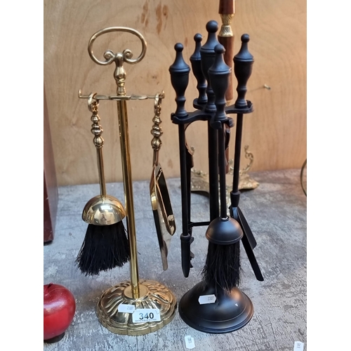 340 - Two fire companion sets including a polished brass example and a black finished example.