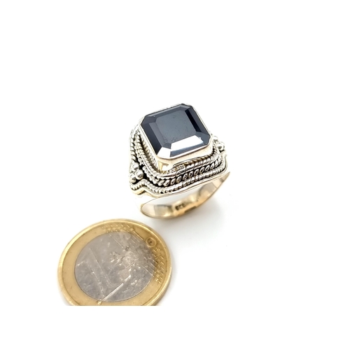 449 - A fine example of a Gents Onyx Moissanite rectangular cut ring, of 6 carats and set beautifully in s... 