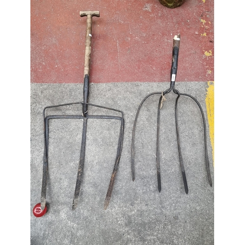 465 - Two impressive antique Irish agricultural tools/pitchforks. With oversized cast iron prongs and a wo... 