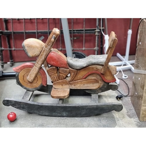 470 - A truly wonderful handmade wooden rocking motorcycle for children. With fantastic coloured accents a... 