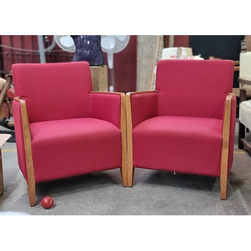 477 - A wonderful pair of armchairs, with high arms, teak frames and rich scarlet upholstery. Very comfort... 