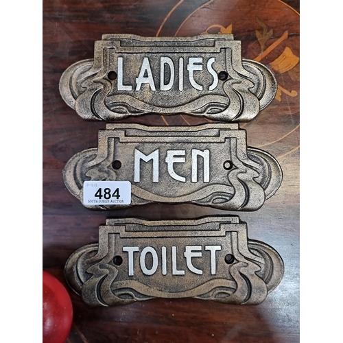 484 - Three heavy cast metal Art Nouveau style toilet signs, reading 'ladies', 'men', and 'toilet'.