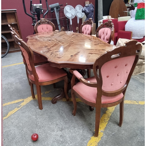 487 - A good vintage dining suite comprising of a large table and six chairs. The table features decoratio... 