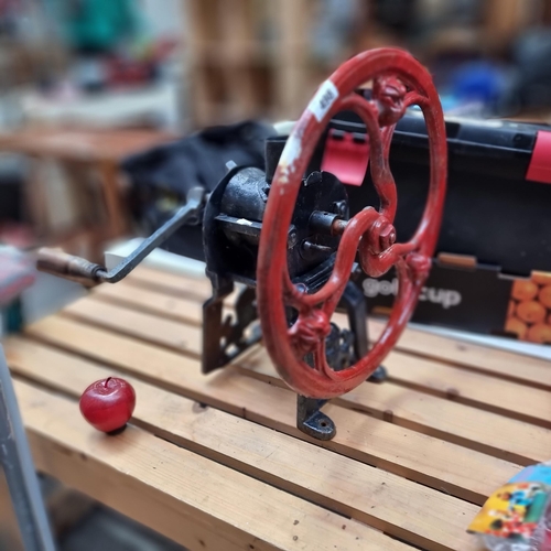 498 - A gorgeous, very heavy antique cast iron grinder with a wooden handled crank. A very well made piece... 