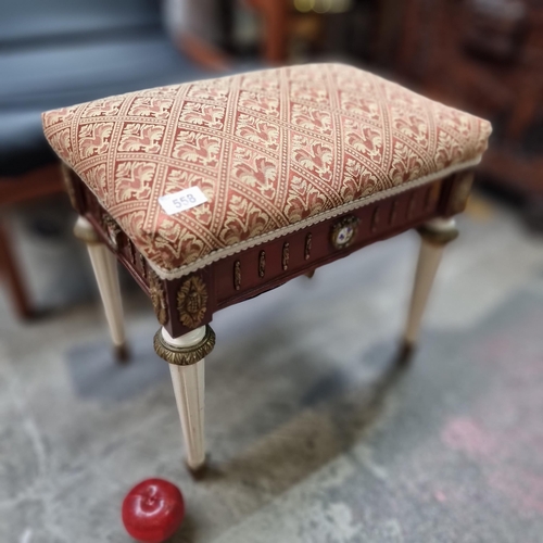 558 - A charming Empire style stool with fluted legs, brass details and upholstered in a red fleur de lis ... 