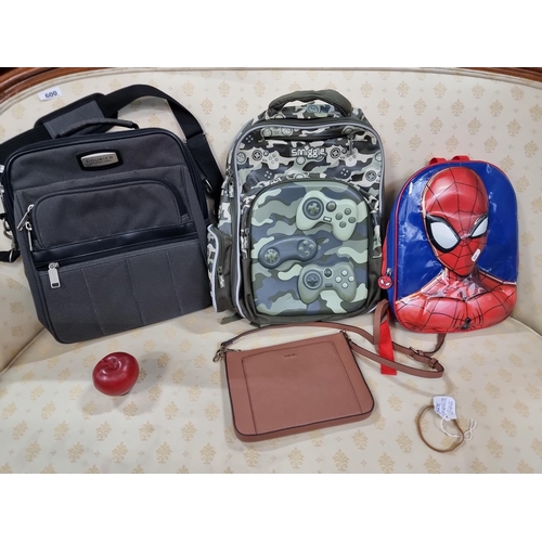 572 - A collection of four bags including a Courrier International example, a Smiggle backpack, a Spiderma... 