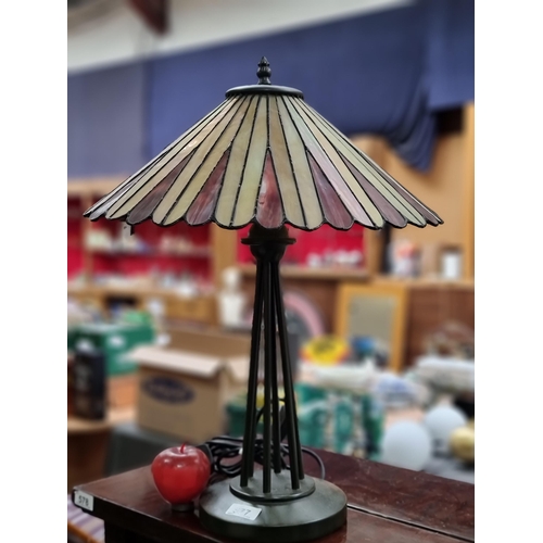 577 - A remarkably heavy table lamp with unusual base and beautiful tiffany style glass shade. Its in love... 