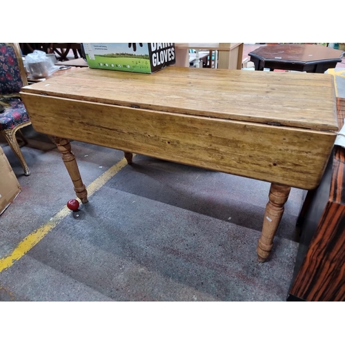 583 - An antique solid oak farmhouse style dining table with drop leaf sides and single drawer to end , al... 