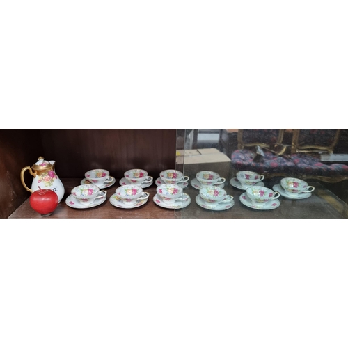 592 - A twenty-three piece tea service including a Royal Chelsea Golden Rose teapot, along with eleven tea... 