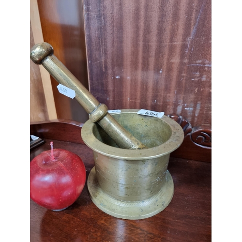 594 - A very heavy large 19th Century brass pestle and mortar, with geometric banding surround. A very hig... 