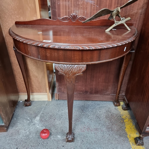 597 - A handsome vintage, demi lune table with gallery back, ball and claw feet and a carved rope border. ... 