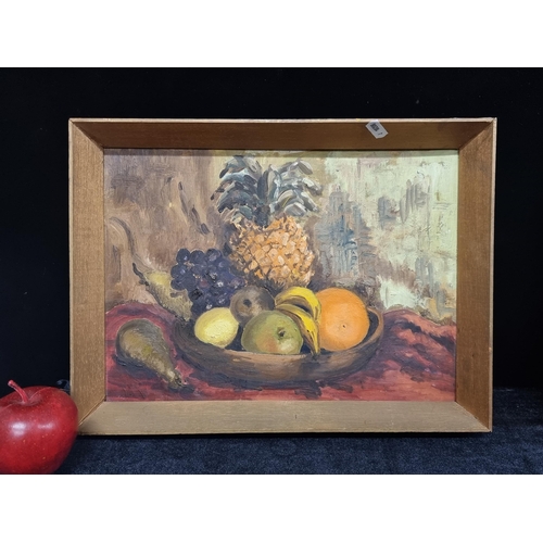 83 - A charming original oil on board painting featuring a still life of fruit in a wooden bowl, includin... 