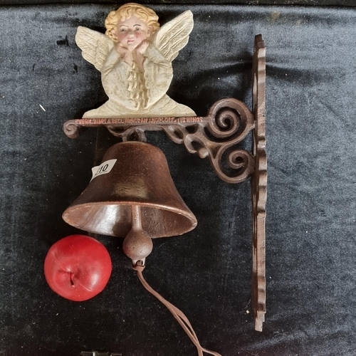 310 - A lovely charming cast metal bell topped with an angel reading 