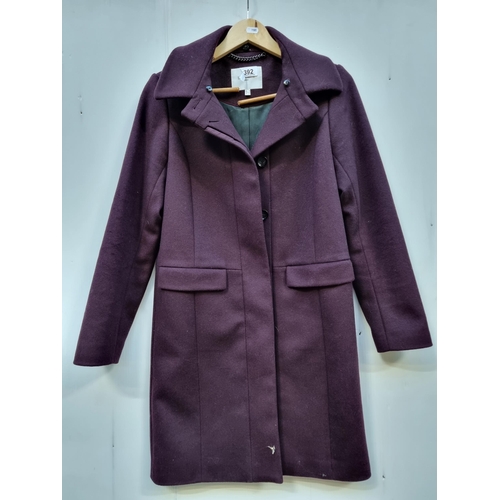 392 - A designer L.K. Bennett lady's wool coat with a cashmere lining, in a UK size 8. A timeless piece in... 