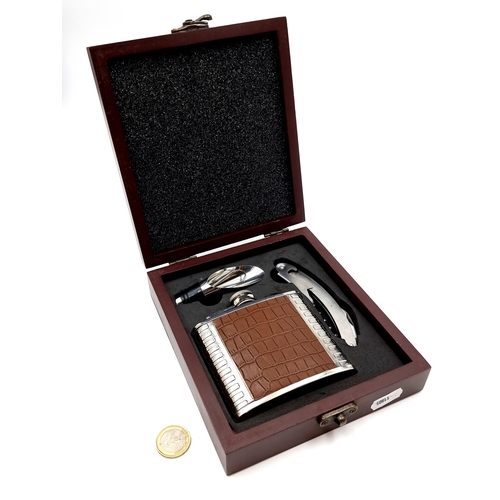 401 - A designer Paul Costello presentation gift box, which contains a stainless steel and leather spirit ... 