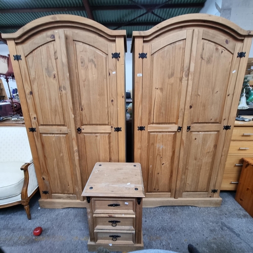 601 - A pair of pine wardrobes with substantial storage space, a shelving unit and hanging hooks. With a m... 