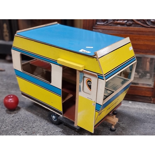 622 - A very nostalgic, hardwood Sindy caravan, with large plastic wheels and screw-jack stablisers. This ... 