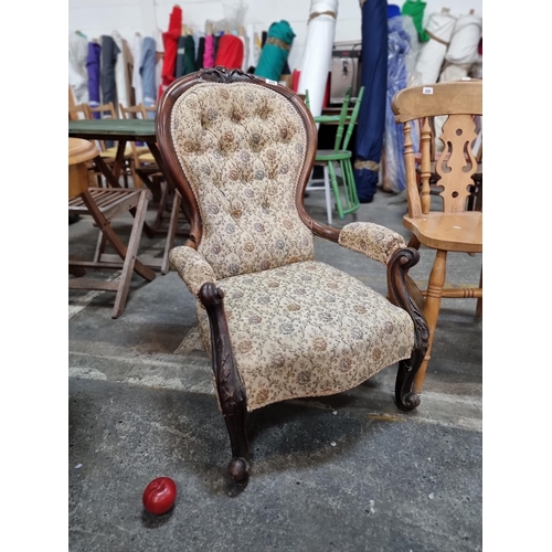 694 - A beautiful example of a Victorian Balloon-back armchair with carved mahogany frame and open arm dei... 