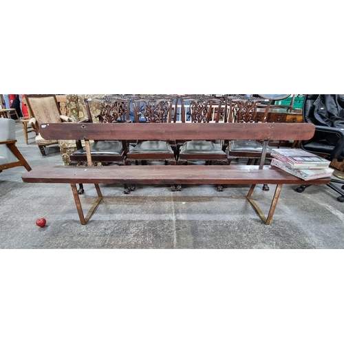 713 - Star lot : A strikingly large wooden garden bench with cast metal frame. May have possibly served as... 