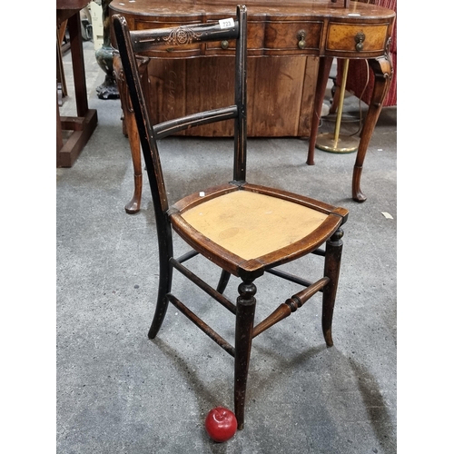 723 - An antique Edwardian wooden chair with carved ornament and turned wood bobbins. (missing pad)