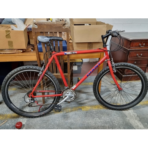 A Giant Boulder 520 mountain bike with Shimano gears in a red finish. Excellent brand would be Appr