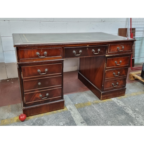 731 - Star Lot : A handsome twin pedestal desk with tooled green leather inlay, ample storage by way of tw... 