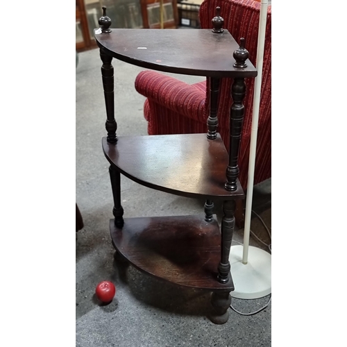 752 - A Victorian corner shelf unit with three tiers, turned wood frame and finials and bun feet.