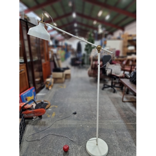 754 - A tall floor standing articulated lamp in a white matte finish.