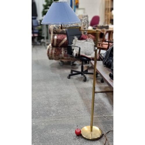 756 - A brass floor standing articulated lamp with light blue shade in good order.