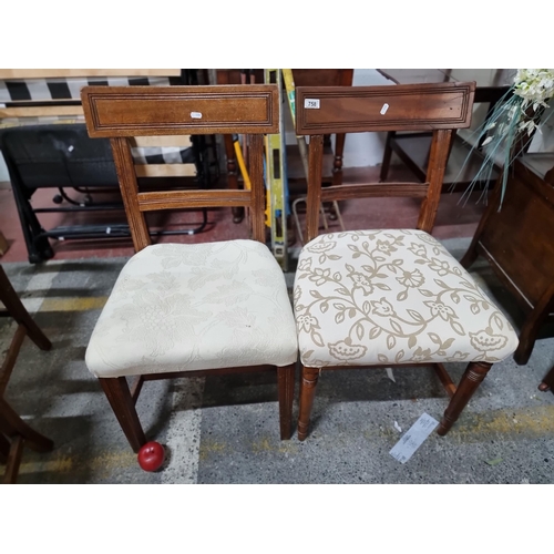 758 - Two vintage wooden ladder back chairs with reeded detail and upholstered in cream fabric.