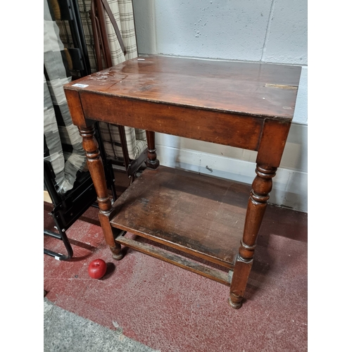 760 - A Victorian side table with lower tier for storage and turned wood legs and bun feet.