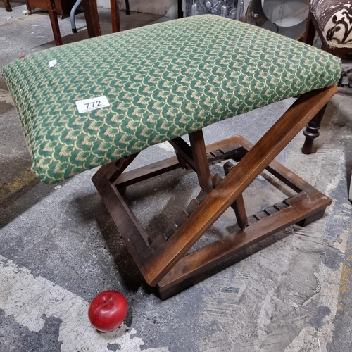 772 - A vintage fully adjustable foldaway stool, upholstered in a green ogee patterned fabric.