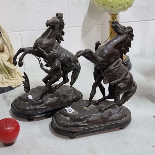 773 - A pair of antique metal sculptures of rearing Marley horses and their handlers. In good order from t... 