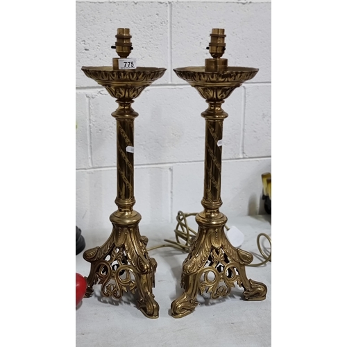 775 - Star lot : A pair of heavy antique , polished brass table lamps with intricate curvilinear foliate o... 