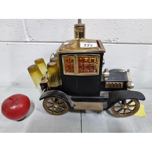 777 - A fantastic vintage novelty drinks holder in the form of an old motorcar. Features amber glass decan... 