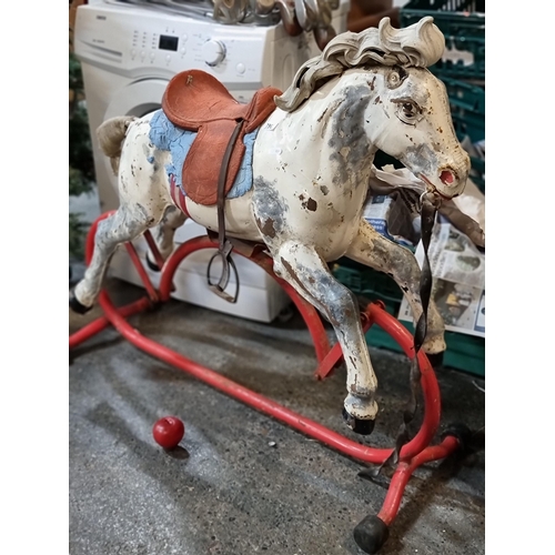 796 - A vintage 1950s rocking horse by Triang Limited. Constructed with a metal frame and realistic rubber... 