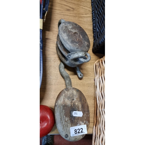 822 - Two antique pulley blocks crafted from wood, with cast metal fittings. Charming collector's items.