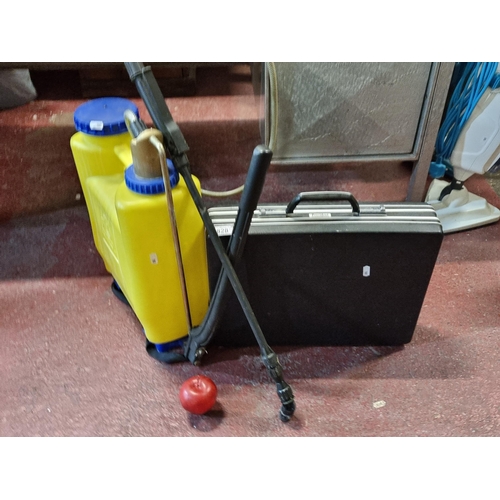 828 - A weed sprayer by Miuba Mythos with a President branded slimline brief case.